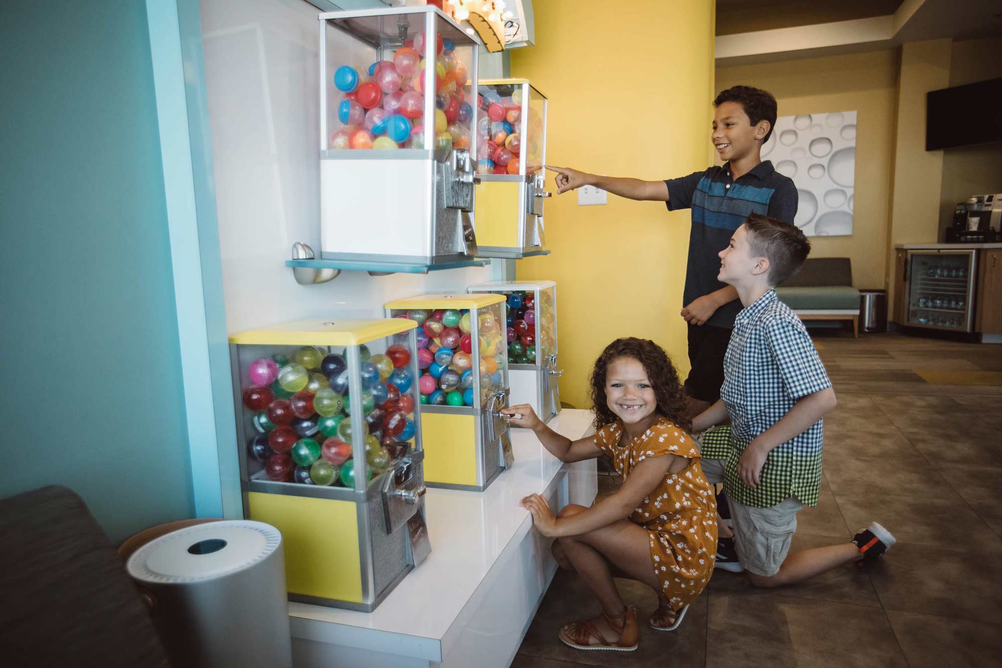 A photo of three children choosing prizes from our price machines.