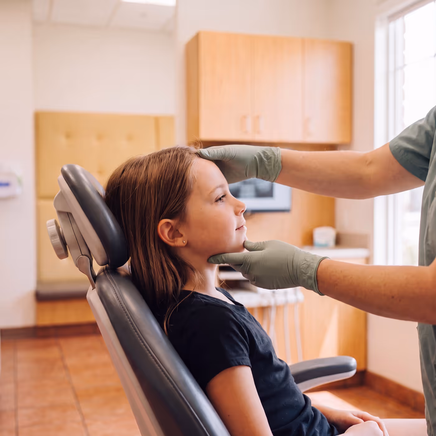A child's jaw and bite being assessed during a growth and development check